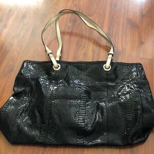 Wilson’s Leather black snakeskin tote bag.